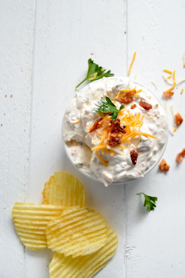 This 3 ingredient dip is the perfect appetizer for your next game day celebration! Everything you love in a baked potato on top of your favorite potato chip! You won't believe how easy this dip is AND you won't want to share!