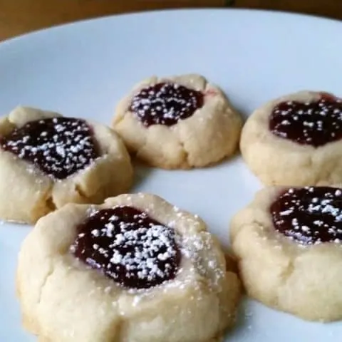 Lemon and raspberry pair perfectly in these buttery thumbprint cookies! Perfect for gift giving or sharing with friends or family these lemon raspberry thumbprint cookies are easier than you might think!