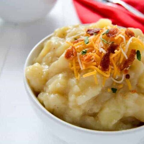 Crock pot baked potato soup is creamy and delicious without using any heavy cream. Try this slow cooker loaded baked potato soup to warm you up this winter!