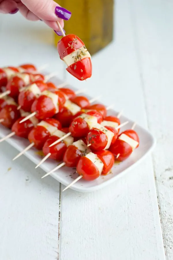 Grape tomatoes and mozzarella make the easiest, make ahead caprese bites. They are the perfect appetizer for your next party or office gathering!