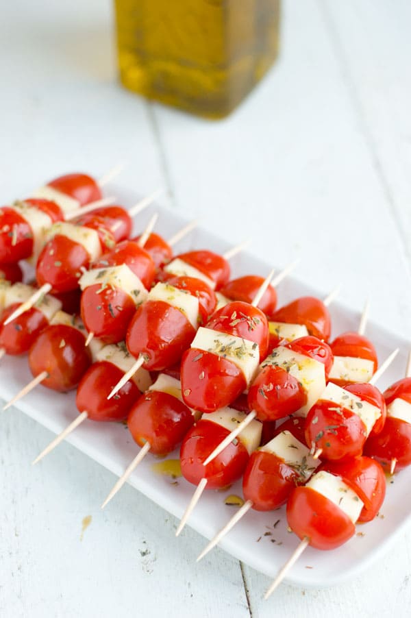Grape tomatoes and mozzarella make the easiest, make ahead caprese bites. They are the perfect appetizer for your next party or office gathering!