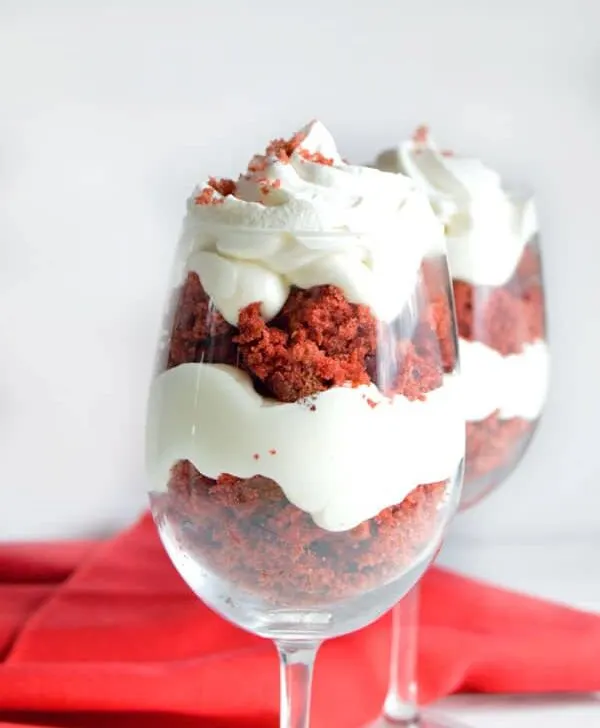 Red velvet cake is the star in this simple and delicious trifle made with vanilla pudding and red velvet cake. Wow your honey this Valentine's Day with this easy red velvet trifle!