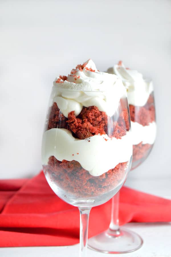Red velvet cake is the star in this simple and delicious trifle made with vanilla pudding and red velvet cake. Wow your honey this Valentine's Day with this easy red velvet trifle!