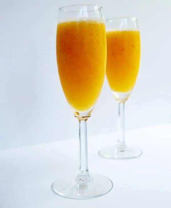 Cool down this summer with a delicious peach bellini and change it up by using your favorite frozen fruit to make your own perfect bellini