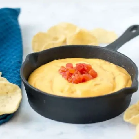 Queso dip topped with a little cream cheese is one of my favorite ways to eat a tortilla chip. And this homemade chipotle cheddar queso dip does double duty and supports small business!