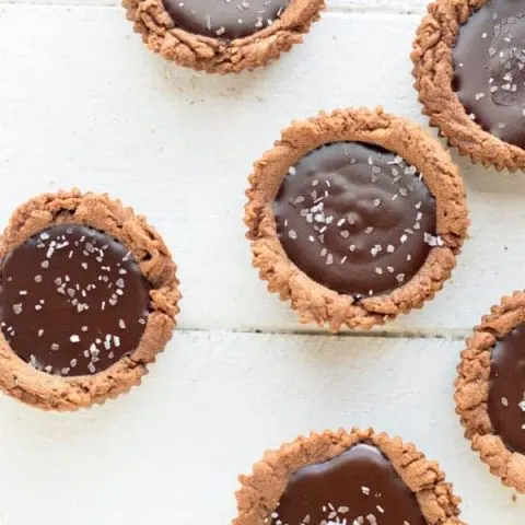 Dark chocolate is transformed into a creamy decadent ganache with a chocolate shortbread crust in these sinful dark chocolate ganache tartlets. You won't be able to eat just one!