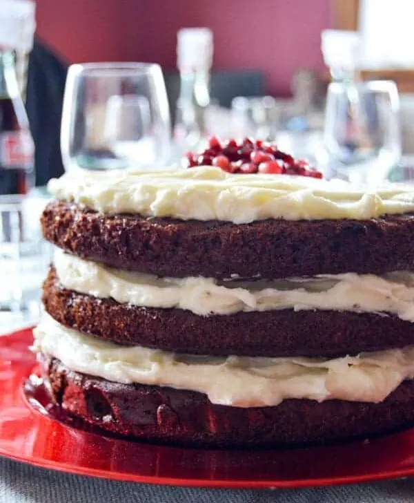 Chocolate cake with mascarpone frosting and pomegranates is a sweet finish to any holiday dinner and perfect for any decadent dessert!