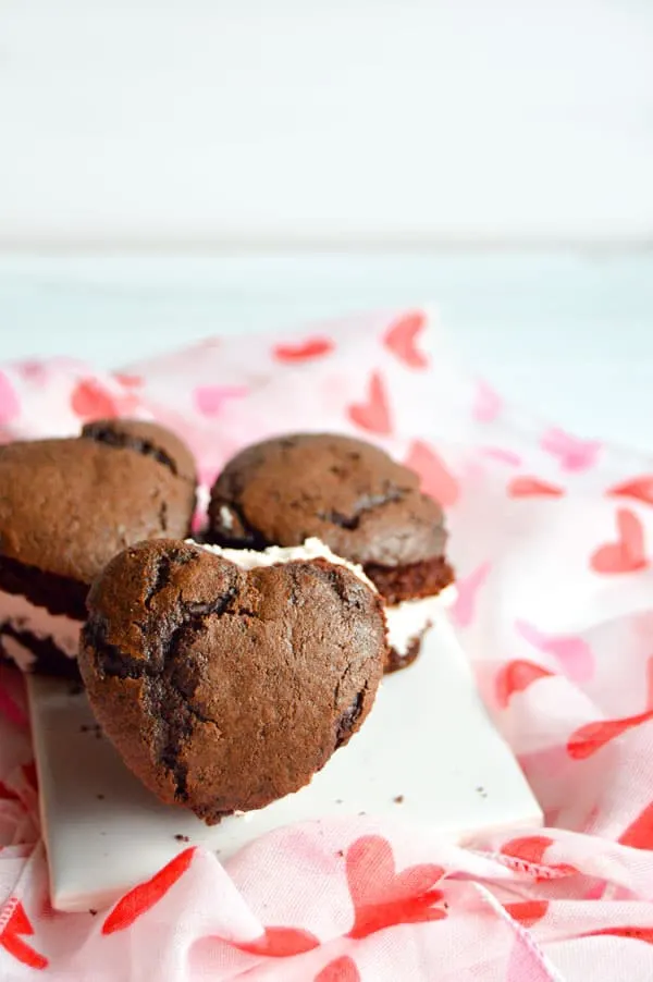 Whoopie pies are an American classic. These heart shaped pies are chocolaty and full of rich raspberry buttercream.