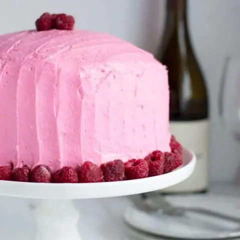 This chardonnay cake is moist with the perfect crumb and topped with sweet raspberry buttercream. It's a great spring recipe and perfect for entertaining!