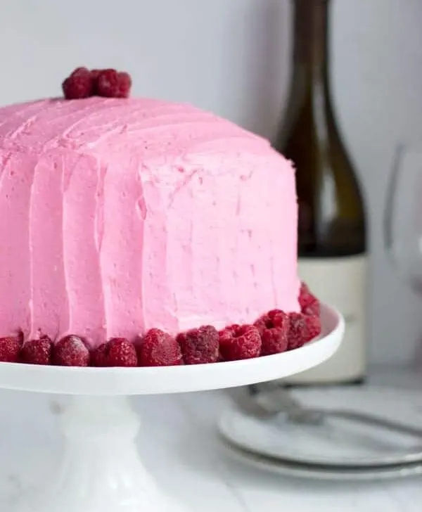 This chardonnay cake is moist with the perfect crumb and topped with sweet raspberry buttercream. It's a great spring recipe and perfect for entertaining!