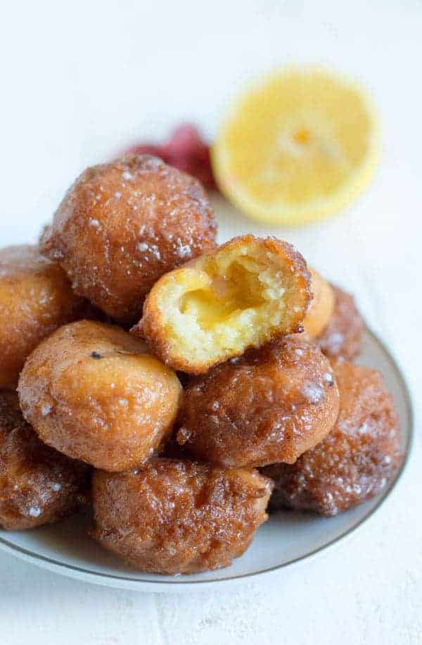 These simple 20 minute donut holes are great for a quick weekday breakfast treat or a simple addition to your brunch table. Filled with lemon curd and coated in a raspberry glaze they're great for spring!