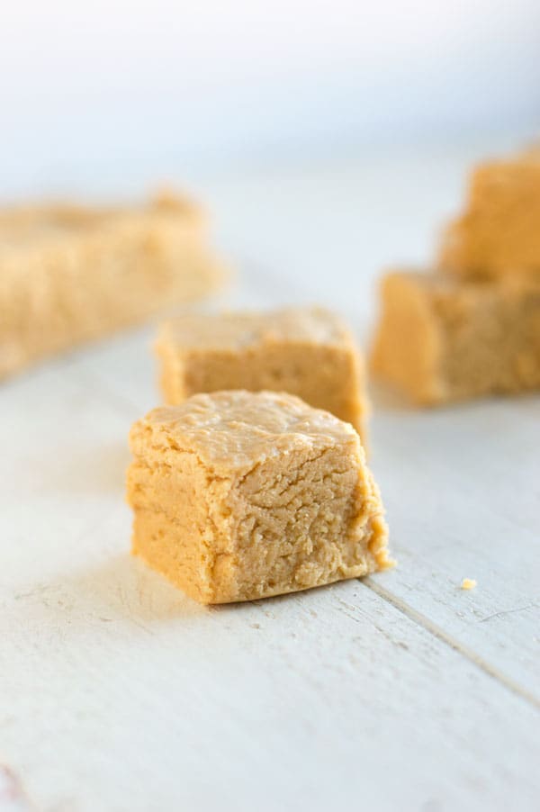 Soft peanut butter fudge is one of my favorite Christmas treats and this recipe comes together super fast with just 4 ingredients! 