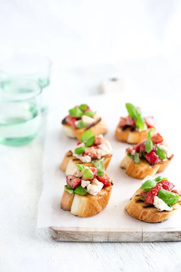 I'm so excited to have Claire from Sprinkes and Sprouts here sharing her amazing Strawberry and Feta Bruschetta! It's the perfect summer appetizer for a crowd!