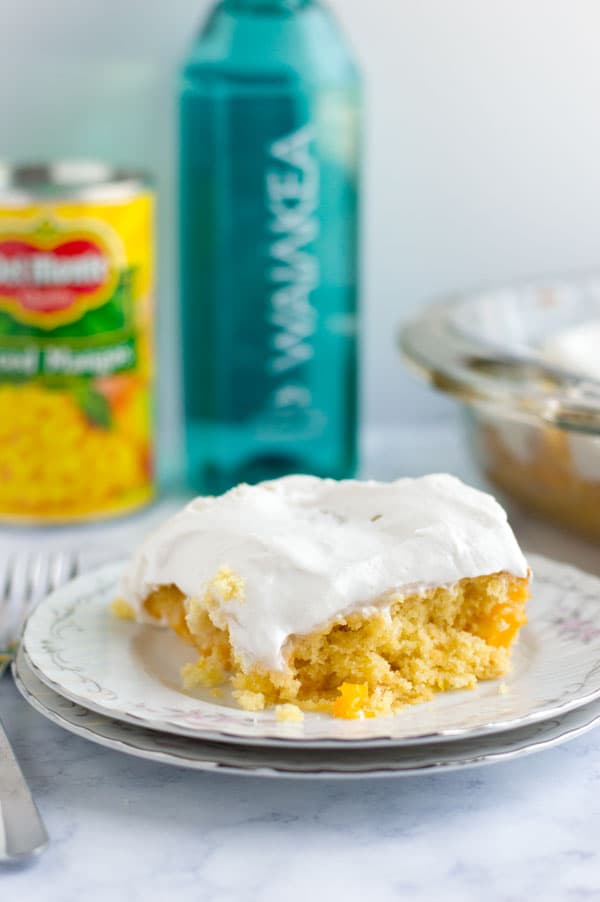 This tropical mango poke cake is the perfect marriage of tropical Hawaiian flavors and a fun southern classic dessert. This tropical poke cake is perfect for National Hawaiian Foods Week!