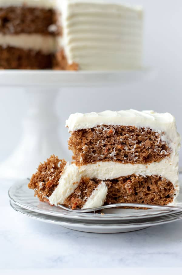 This is Best Homemade Carrot Cake Recipe You’ll Ever Make. No, really. This really is the best homemade carrot cake recipe you’ll ever make. Moist, perfectly spiced, and without getting carrot shreds stuck in your teeth! Your families will love this easy dessert. Plus it is topped with decadent cream cheese frosting. #carrotcake #homemade #recipe #dessert #cake